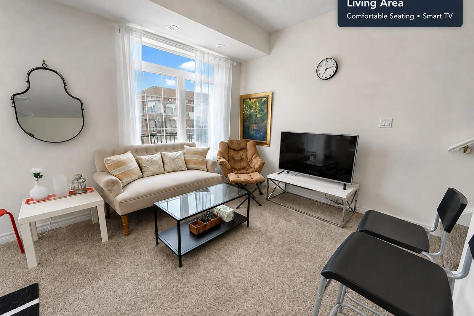 Open-concept living room with a sofa, armchair and wall-mounted television