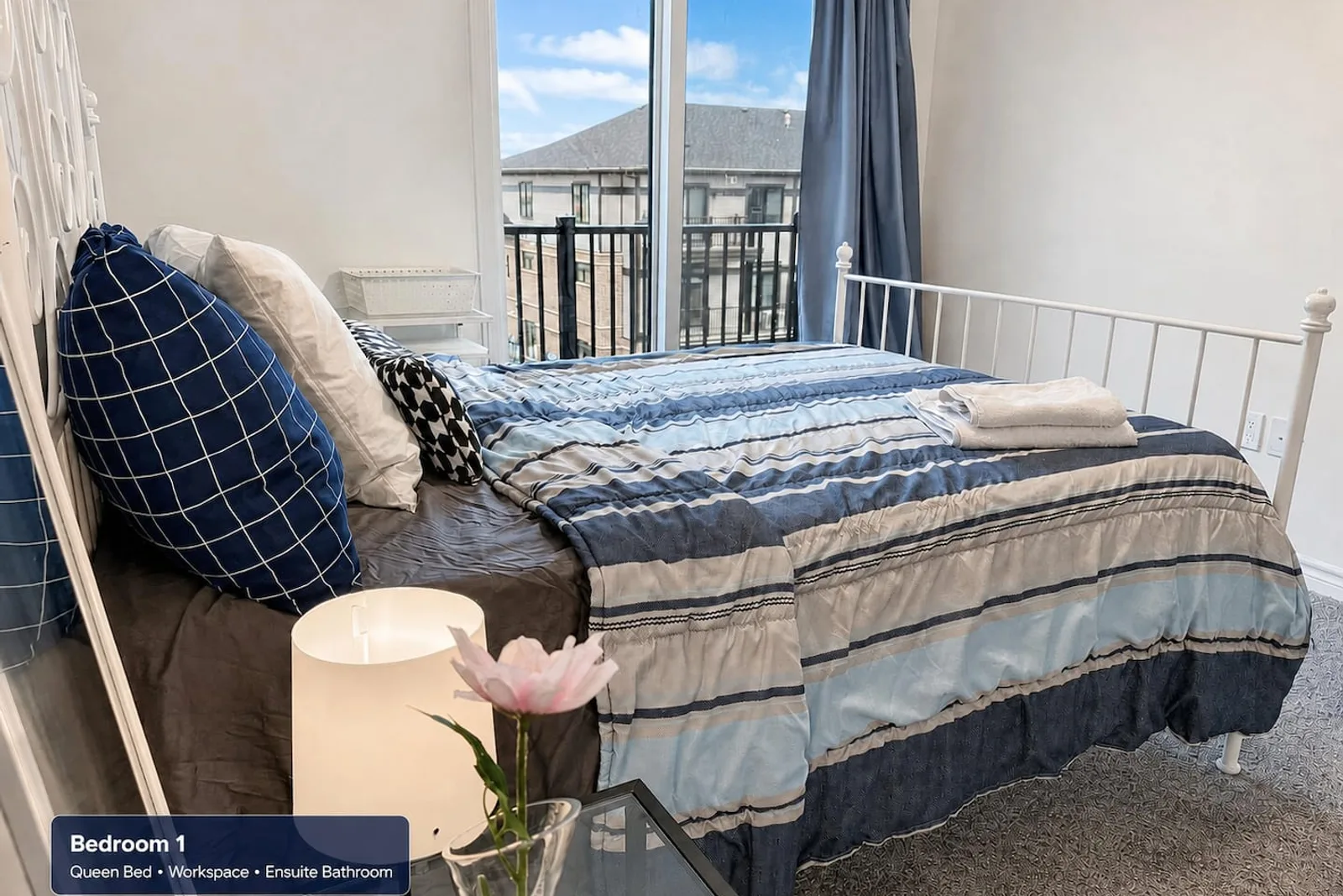 Primary bedroom with a queen bed and room-darkening shades
