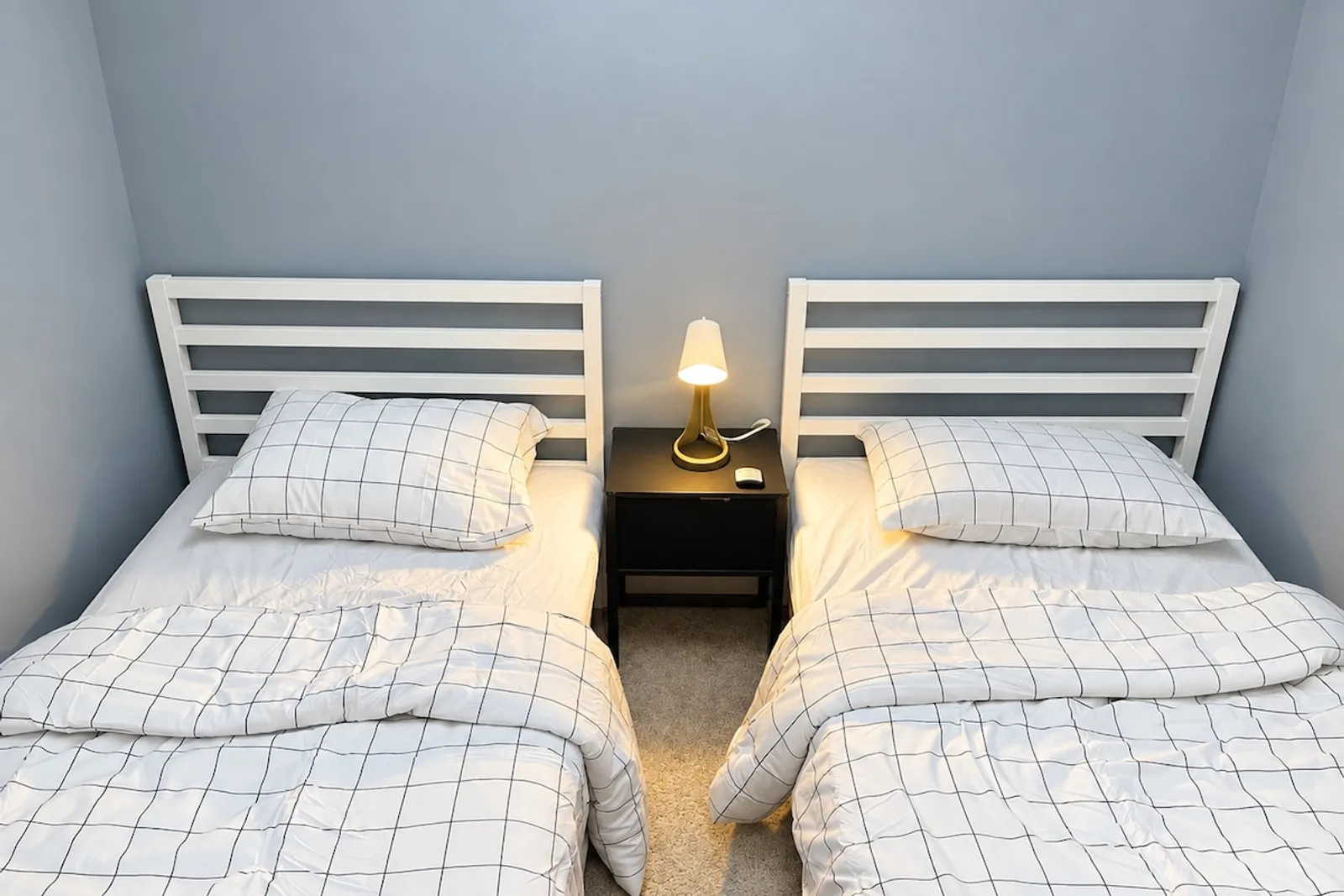 Third bedroom with two single beds and a shared nightstand